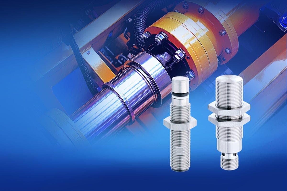 Two stainless steel Contrinex sensors in front of a hydraulic cylinder