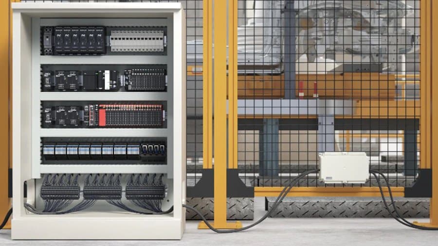 Illustration: a large control cabinet full of devices, with complex external wiring